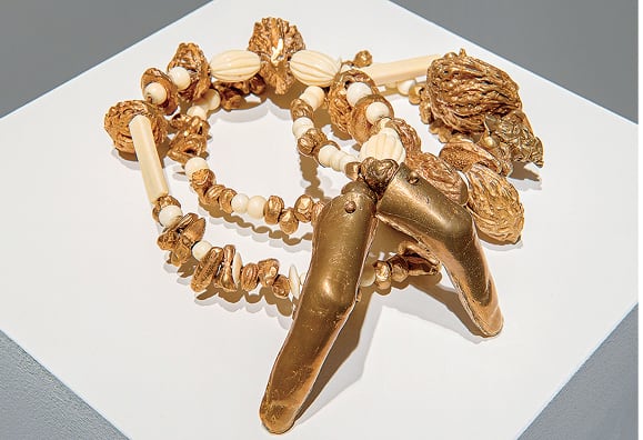 Elizabeth Zvonar, <em>Tiny Devotions</em> 2015. Bronze casts of fruit pits including date, cherry, apricot, peach and nectarine, teeth, marijuana buds, has balls and antique ivory beads. 9″ × 8″ × 3″. Courtesy the artist and Daniel Faria Gallery