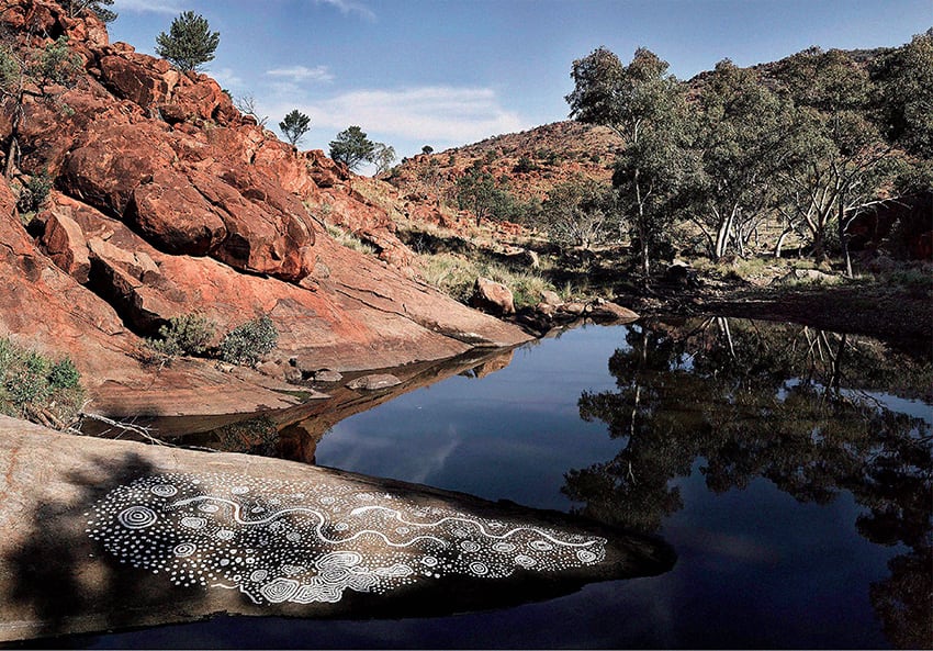 Fig. 5  Keith Stevens, <em>Piltati</em>, 2017. White pigment ‘Tutu’ on rock at Piltati rock hole. Inkjet print, 150 x 240 cm Courtesy of Tjungu Palya and the artist Tjungu Palya is an Indigenous owned and operated art centre run out of Nyapari in the APY Lands. Prints from this project are available to purchase online, along with a collectors edition publication detailing its process, with proceeds supporting the artists and their communities. www.tjungu.com  @tjungu_palya_arts 