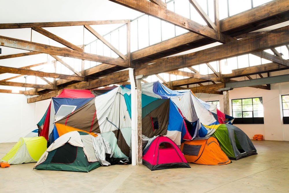 Keg de Souza, 'We Built This City' (2016), tents, tarps, hessian sacks, piping, plaid laundry bags, found and recycled materials, 16 Vine St, Redfern. Image courtesy of the artist. Photo credit: Ben Symons.