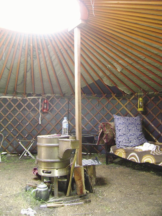 Inside the yurt. Note the the beer-keg oven, chess board and circular opening (known as a Toono).