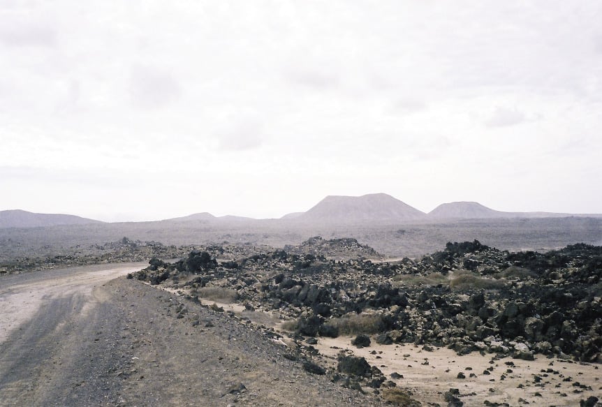 Photograph of landscape on Fuerteventura, Canary Islands, taken by the author as a reference image during his search for Social Realism, November 2012. The majority of the environment was composed of volcanic rock, with no verdant aspect in the transition from land to sea.