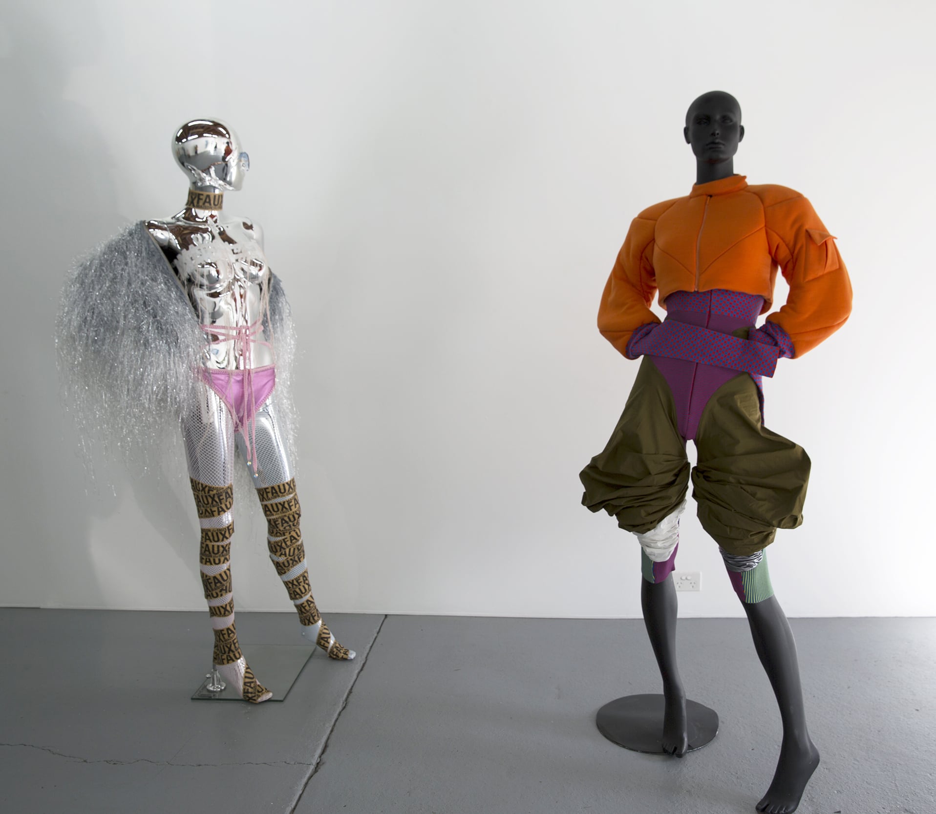 Image 03: Installation view, Gallery 1 L-R: Maison the Faux, untitled – sloppy handwoven fringe coat, handwoven recycled denim fringe coat, presented 2016; Laura / Deanna Fanning, The Tell, 2018, wool, lycra and cotton. Image: Rafaela Pandolfini.