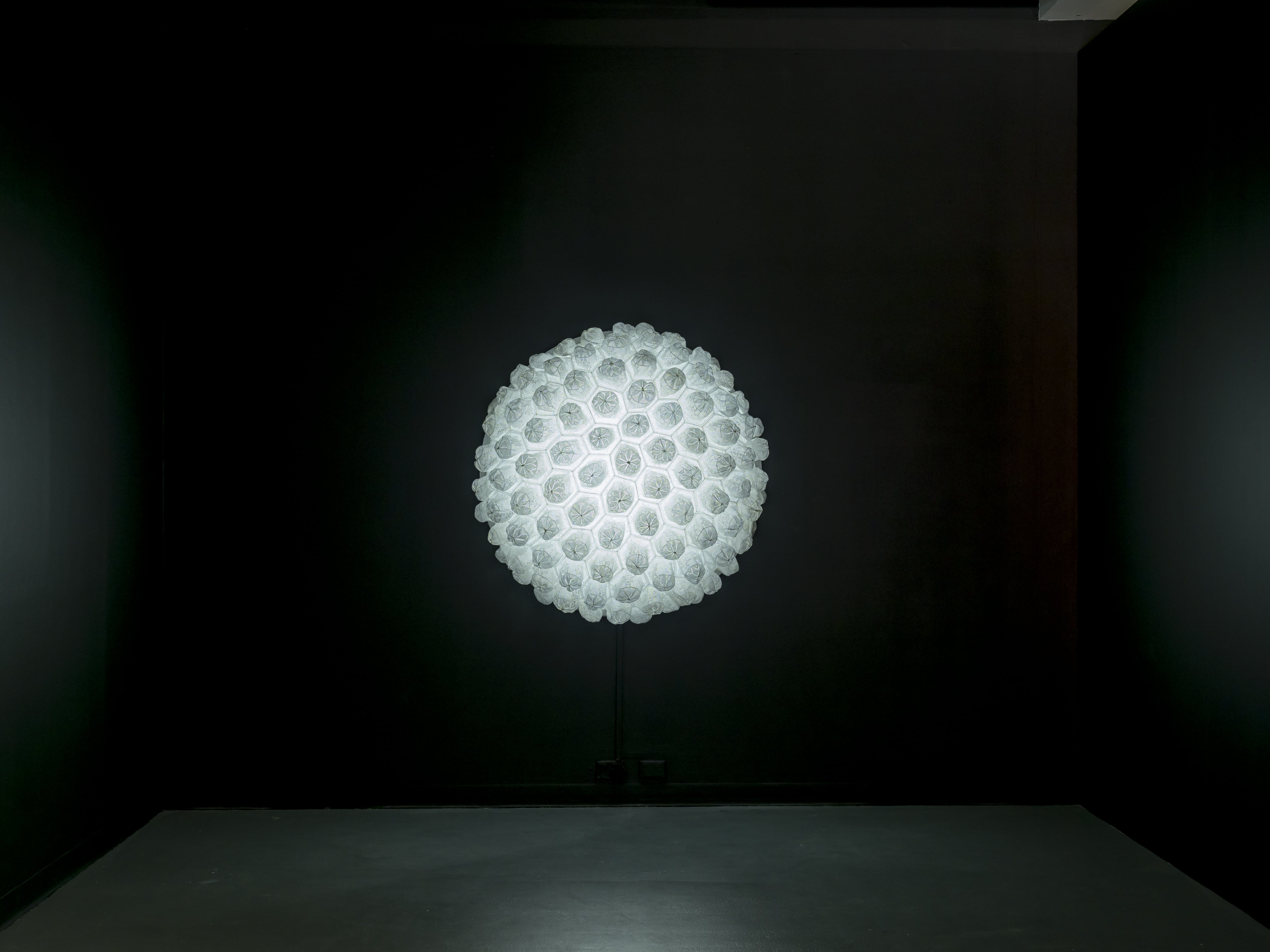 Image 03: Abdullah M. I. Syed, Aura II (2013), installation view, hand-stitched white crocheted prayer caps (topi), Perspex and LED light, 127 (d) x 54c,. Courtesy the artist.