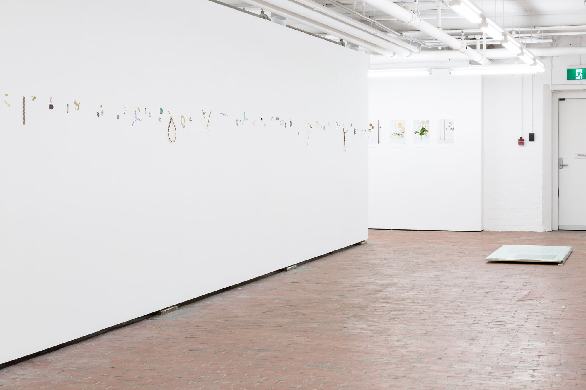 Image 01: SHE TURNS installation view. Left: Rebecca Thomas *On Divers Arts* 2017, assorted materials. Rear: Meredith Turnbull *Flowers and Mirrors* 2017, archival pigment prints on Hahnemühle photo rag paper. Floor: Meredith Turnbull *Paper Portraits* 2017, glass, paper, particleboard, acrylic paint, aluminium. Images courtesy the artists. Photo: Vivian Cooper Smith.