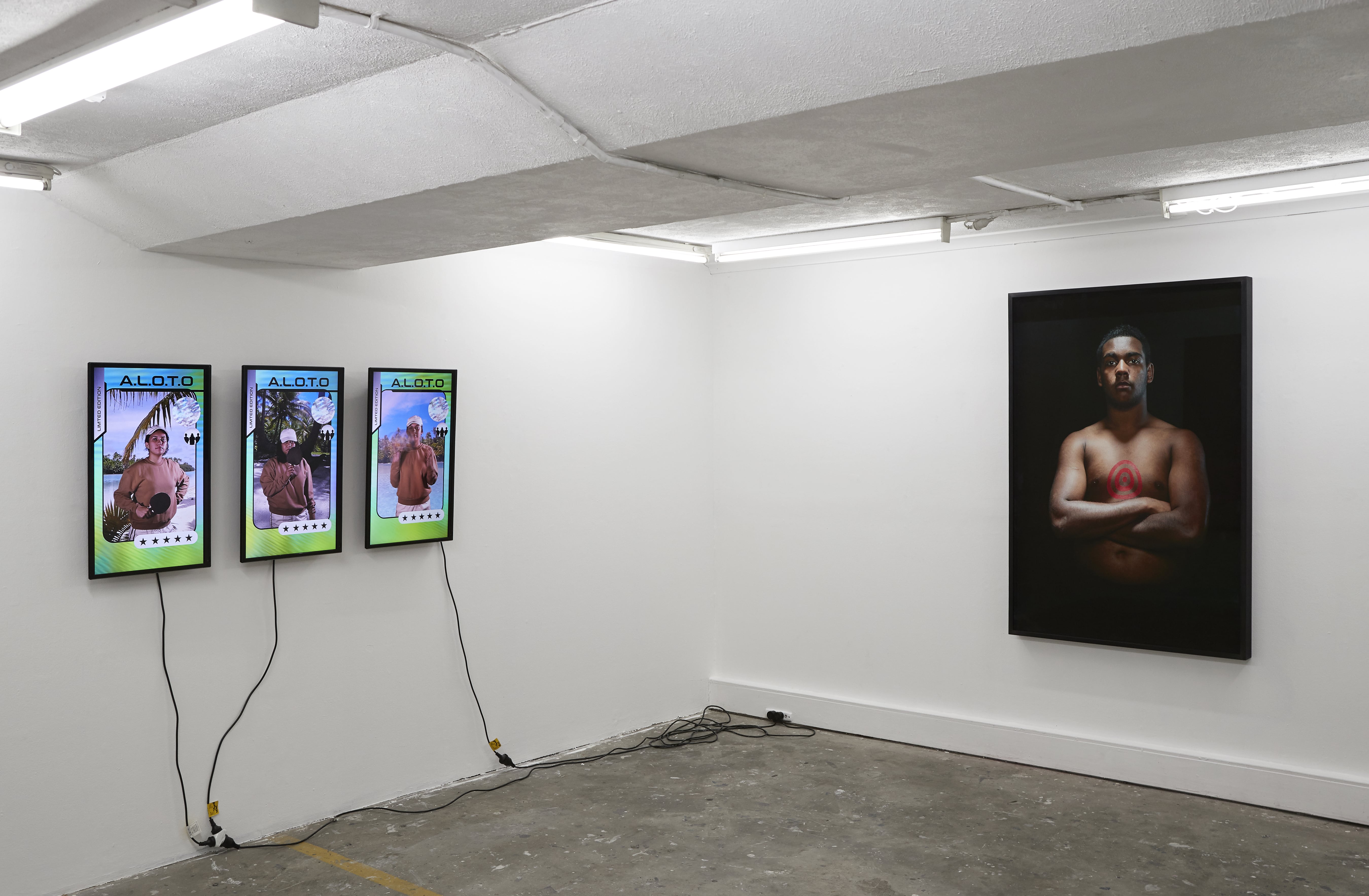 Image 01: Installation view of Get To Work (Tracy Quan, Georgia Taia and Paris Taia); a.l.o.t.o (a league of their own) 2017, three-channel digital video & sound; Tony Albert *Brother (Our Present)* 2013, pigment print on paper 150x100cm, courtesy the artist and Sullivan+Strumpf. Photo credit: Zan Wimberley.